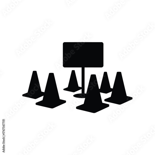 Black traffic cones arranged around a signpost