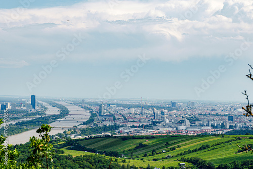 Photography Cityscape Panorama with River, Bridges, and Green Hills under Blue Sky