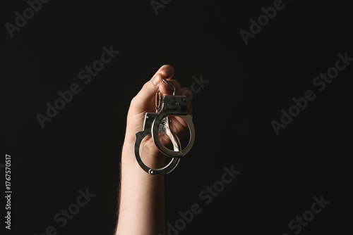 Male hand in handcuffs on b...