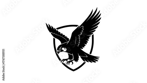 A silhouette of a bird of prey with outstretched wings, inside a shield