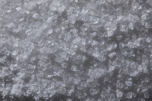 Coarse gray salt crystals forming a textured background, showing mineral structure and organic crystalline pattern