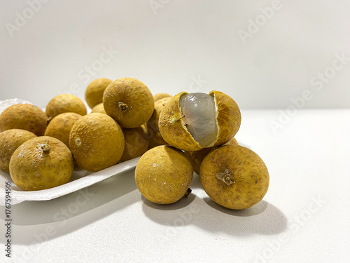 Fresh longan fruit isolated on white background. Tropical exotic fruit minimal still life. Organic longan close up. Sweet healthy fruit photography. Natural clean food concept.