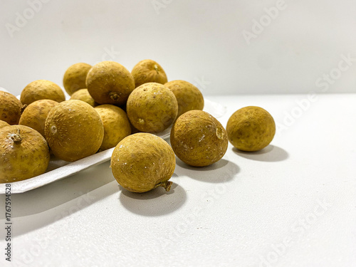 Fresh longan fruit isolated on white background. Tropical exotic fruit minimal still life. Organic longan close up. Sweet healthy fruit photography. Natural clean food concept.