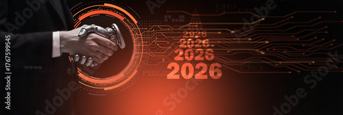 A businessman shaking hands with a futuristic robotic hand over a digital circuit background with the year '2026', symbolizing AI partnership, future business deals, and technological collaboration.