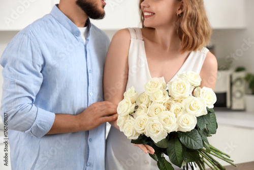 Happy couple with white ros...