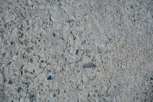 Rough gray concrete surface background with natural stone grain pattern