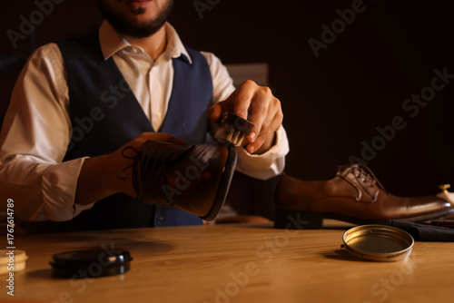 Man polishing shoe with bru...