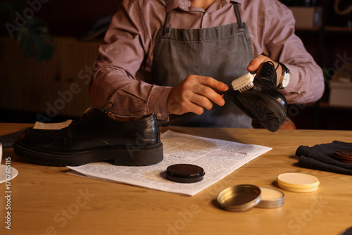 Male shoemaker polishing sh...