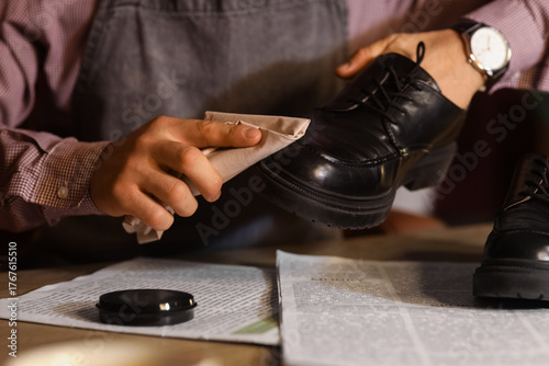 Male shoemaker polishing sh...