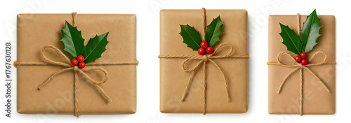 Eco style gift boxes wrapped in kraft paper with holly (Ilex) — natural Christmas and New Year packaging