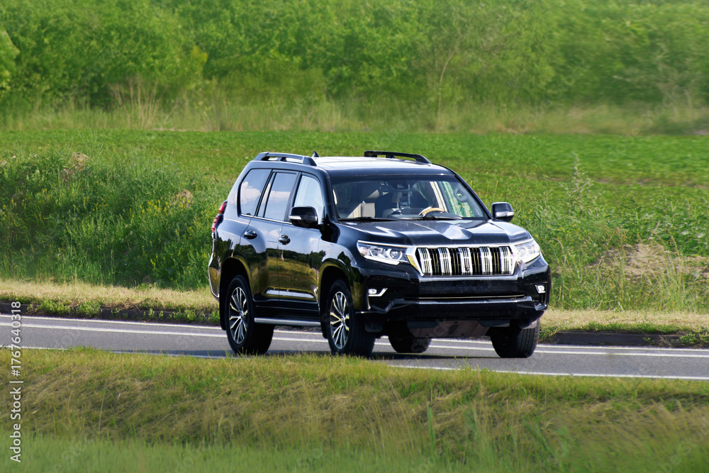 Fototapeta premium Adventure SUV traveling on forest road in summer