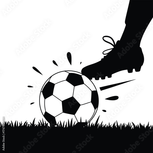 Silhouette of a soccer player kicking a ball on grass