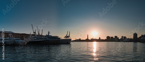 harbor with lighthouse of Genoa at sunset in Italy