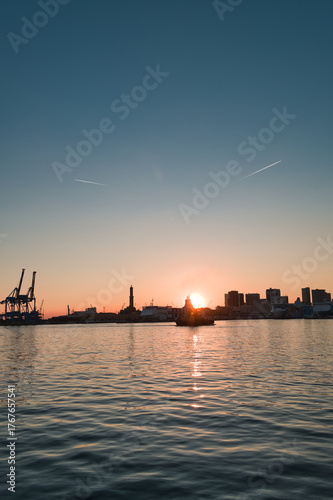 harbor with lighthouse of Genoa at sunset in Italy