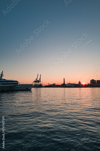 harbor with lighthouse of Genoa at sunset in Italy