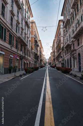 Via Roma in the city of Genoa under a blue sky in the morning