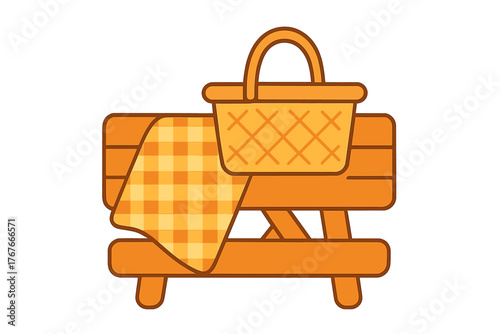 Traditional picnic basket and orange checkered blanket resting on a wooden outdoor table
