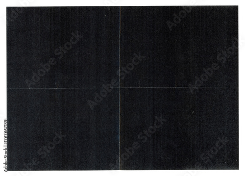 Scanned black paper texture with visible fold lines and subtle grain. High-resolution dark background showing creases and fine surface details.