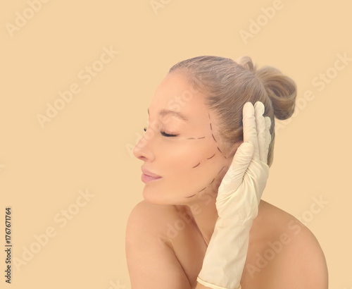 Marking the face.Perforation lines on females face, plastic surgery concept.