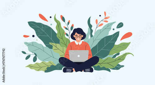 A young woman sits cross-legged surrounded by lush green and orange foliage while happily working on her laptop.