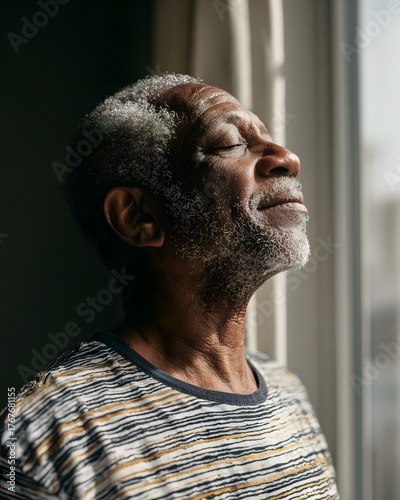 senior man doing deep breathing exercise near window