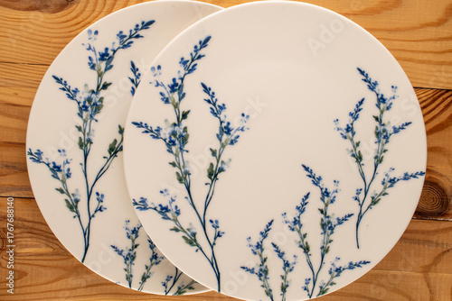 Ceramic plate on a wooden table, top view.