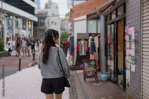 Rear view of woman browsing shops on Harajuku street