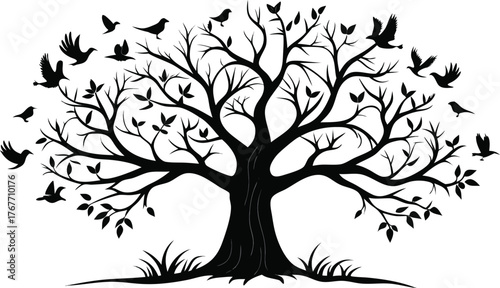 Silhouette of a large tree with many birds flying around it