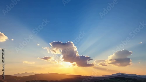 Majestic Sunbeams Shine Through Clouds Over Rolling Hills at Golden Hour Warm Light Illuminates Scenic Landscape Under a Vast Blue Sky