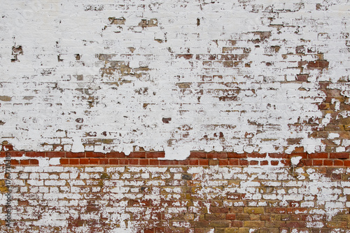Dirty old mixed wall covered with white color
