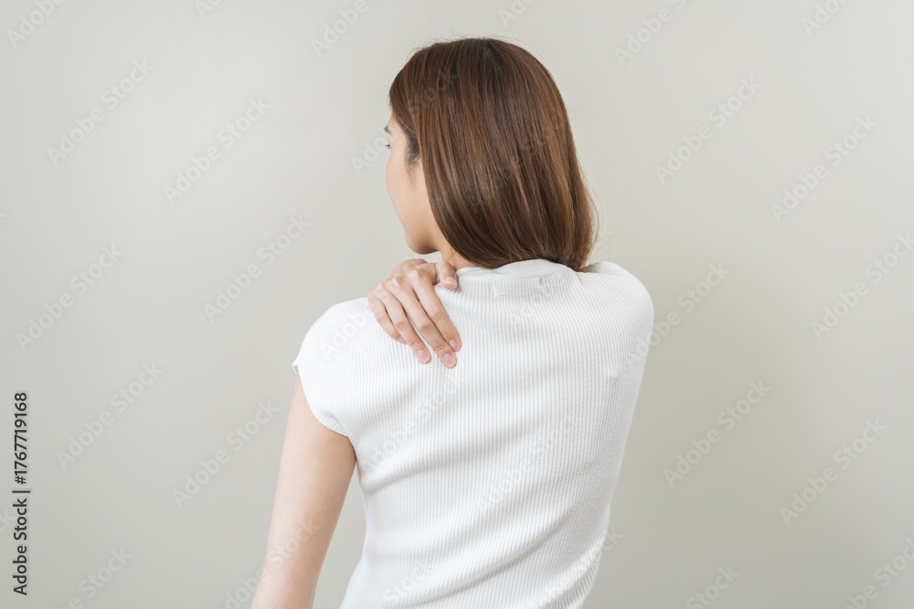 Obraz premium Pain body muscles stiff problem, asian young woman, girl painful with back, neck ache from work hand holding massaging rubbing shoulder hurt, sore on white background. Health care and medicine concept