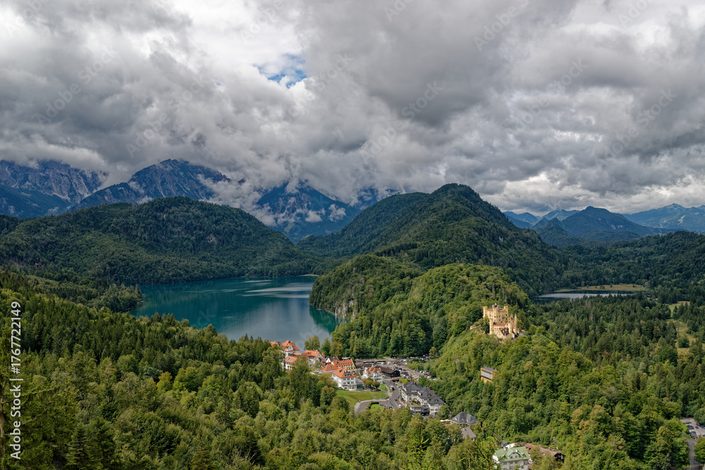 Fototapeta premium A cloudy autumn day near a castle at the foot of the Alps.