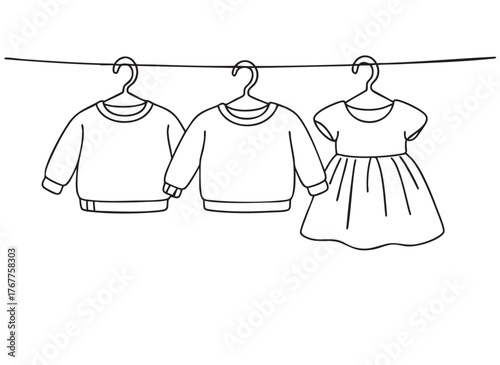 line sketch baby sweaters and dress on hangers