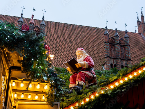 Santa figurine on a roof at a Christmas market. Hannover, Germany