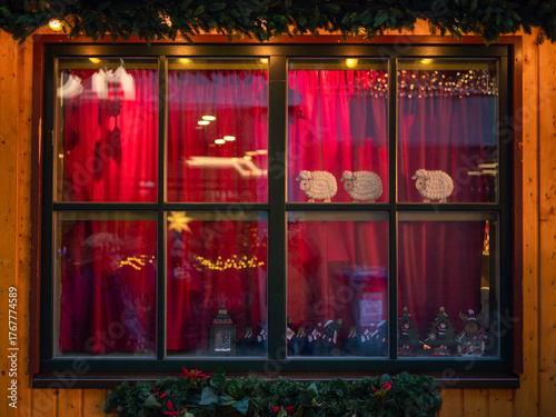 Christmas shop window display with red curtains and Christmas decorations at European Christmas market