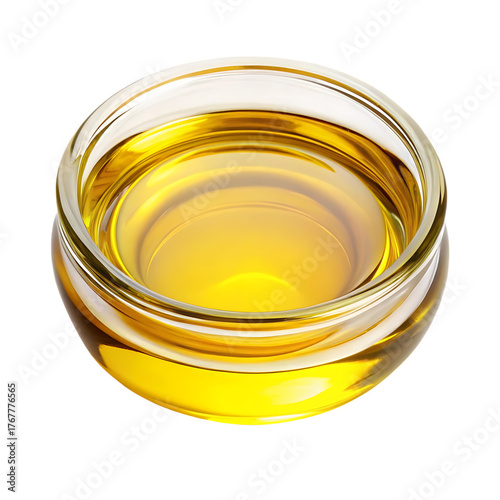 Golden olive oil in a glass bowl isolated on black background studio shot