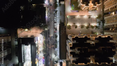aerial drone forward moving shot straight down showing decorated buildings, streets, shopping malls on the eve of diwali with colorful lights, shot in Delhi, Mumbai