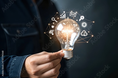Businessman holding glowing lightbulb and question mark with copy space for creative thinking idea and problem solving concept.