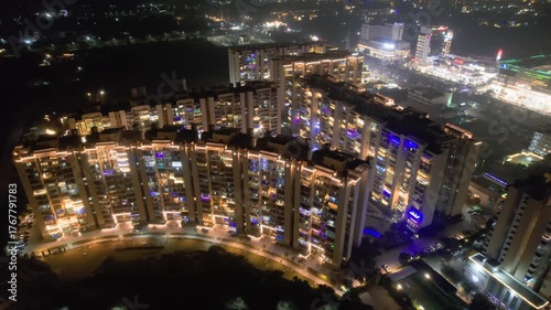 Wallpaper Mural Aerial drone shot showing curved multi storey sky scraper building with apartments decorated with colorful lights showing the celebration on the Indian festival of diwali in delhi, noida, gurgaon Torontodigital.ca