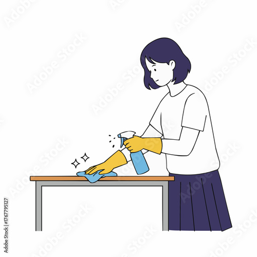 Teen girl wiping desk with spray cleaner while wearing yellow gloves  