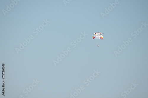 Colorful parasailing adventure over blue ocean water