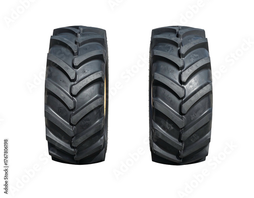 Close-up of two new, clean tractor tires against a stark black background, showcasing their deep, detailed treads