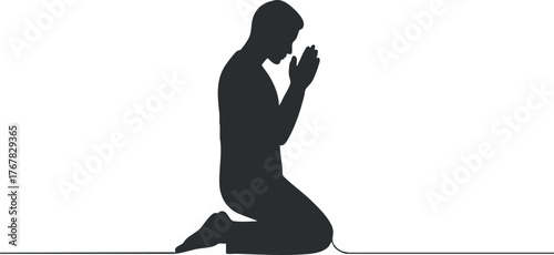 A silhouette of a kneeling man in prayer, symbolizing devotion and spiritual reflection.