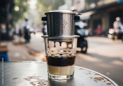 Traditional Vietnamese phin coffee dripping on a rustic Hanoi street