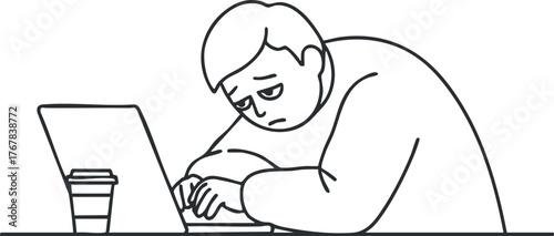 A tired man slumped over his laptop, showing frustration while working in an office environment.