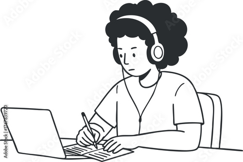 A student engaged in online learning while taking notes with headphones on.