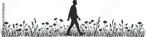 Silhouette of a man walking through a field of flowers in a serene nature setting.