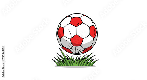 Illustration of a red and white soccer ball sitting on a patch of grass against a stark transparent background.