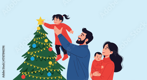 A happy family decorates their Christmas tree for the holidays, with the father lifting his young daughter to place the star on top.