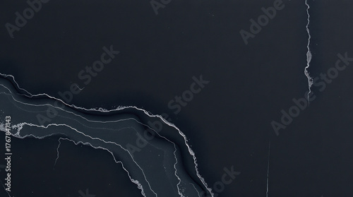 Abstract dark gray background with swirling veins of light gray and white creating a marbled effect